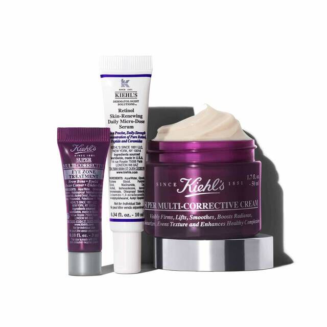 A graphic featuring three Kiehl’s products casting a shadow against a white background: a small purple tube of "Kiehl's Super Multi-Corrective Eye Zone Treatment," a white and purple tube of "Kiehl's Retinol Skin-Renewing Daily Micro-Dose Serum," and an open purple jar of "Kiehl's Super Multi-Corrective Cream" with visible cream.